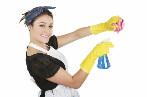 Trained carpet cleaner using protective gloves and safe cleaning practices